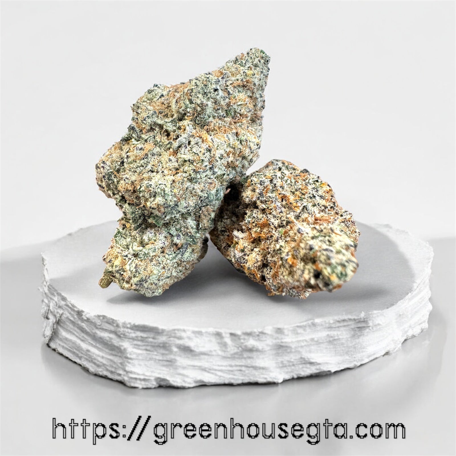 Diamond Death AAA Indica 28% THC – OG earthy aroma, dense indica bud on white marble – GreenHouseGTA Toronto delivery
