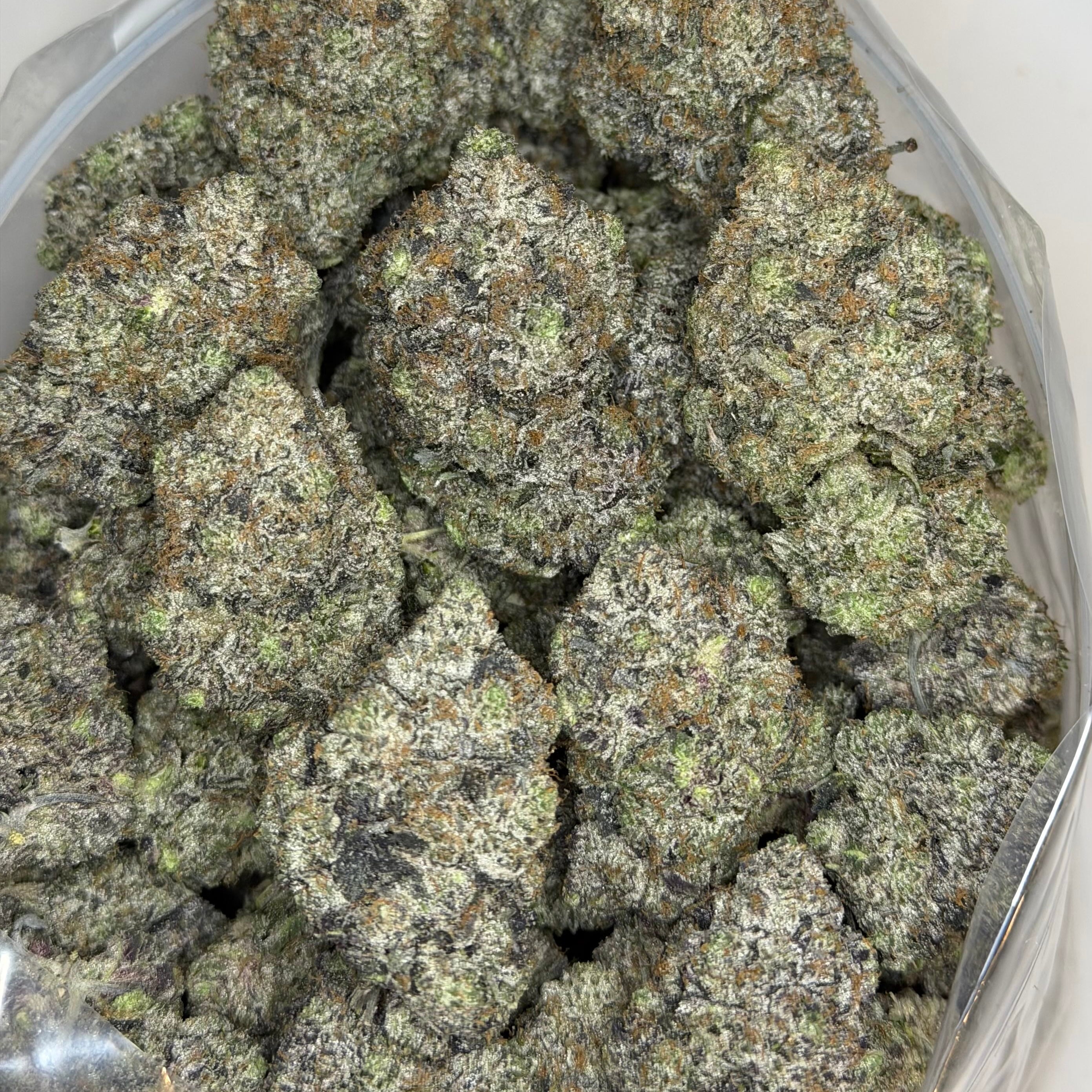 Super Goo high THC hybrid indica buds featuring white ash quality and smooth smoke